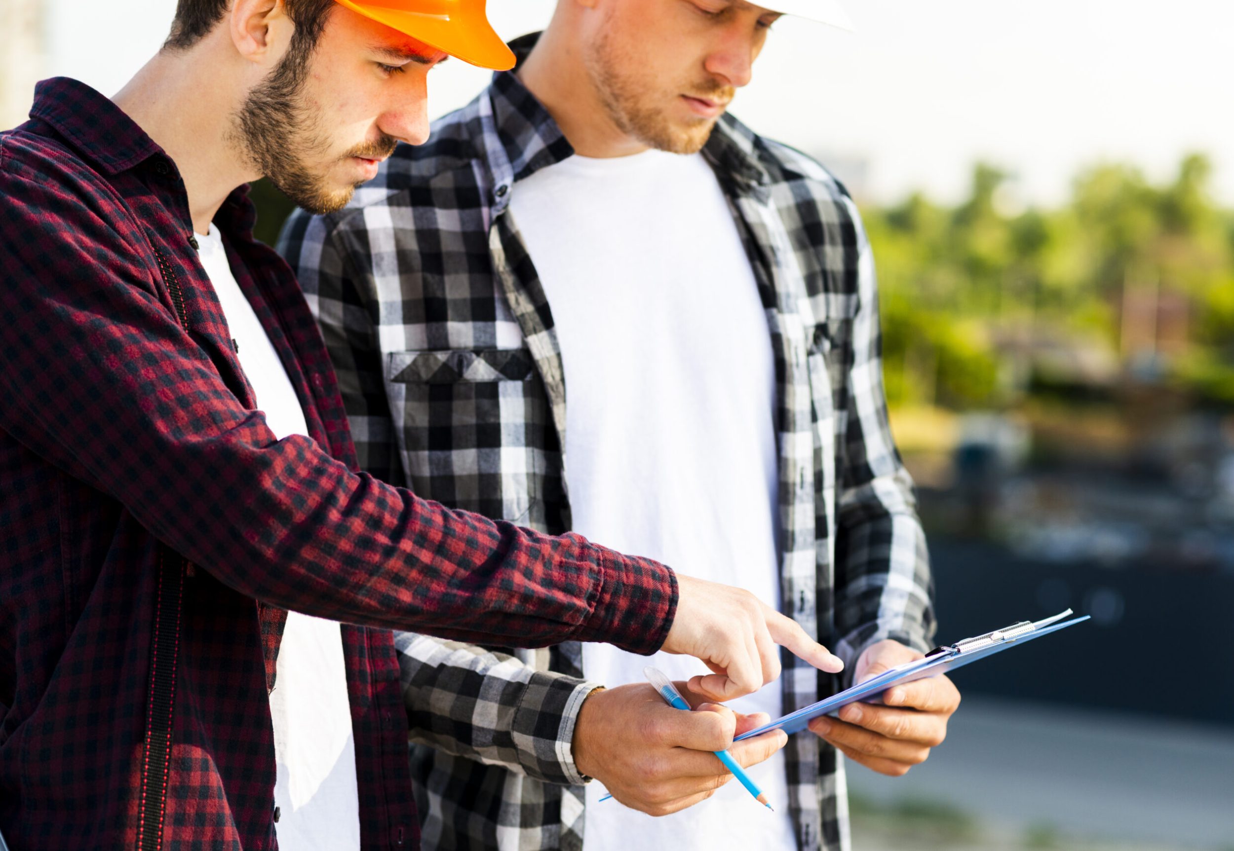 close-up-engineer-architect-looking-clipboard